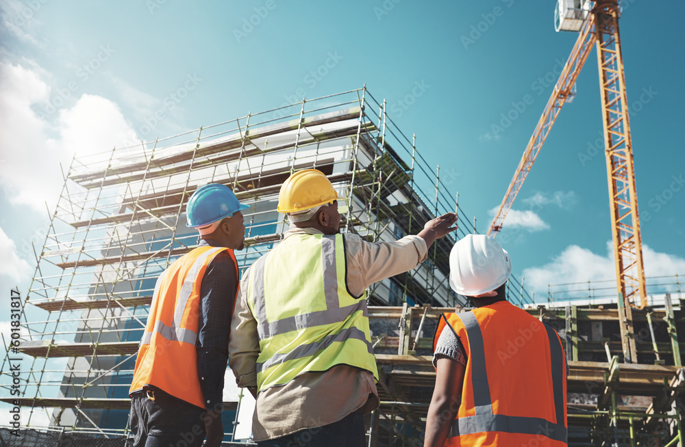 building under construction with engineers looking at it